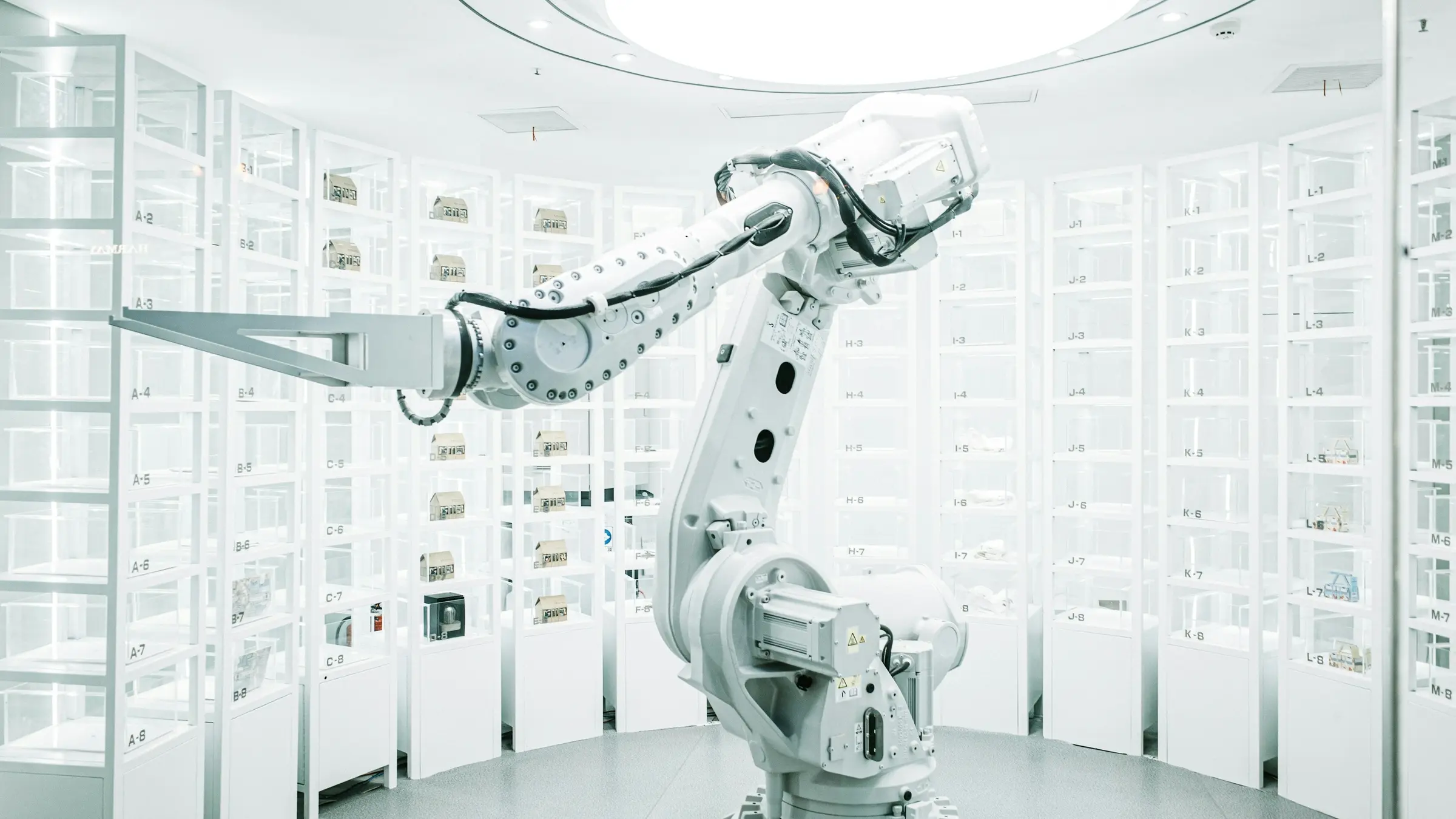 White industrial robot arm in a bright automated workspace
