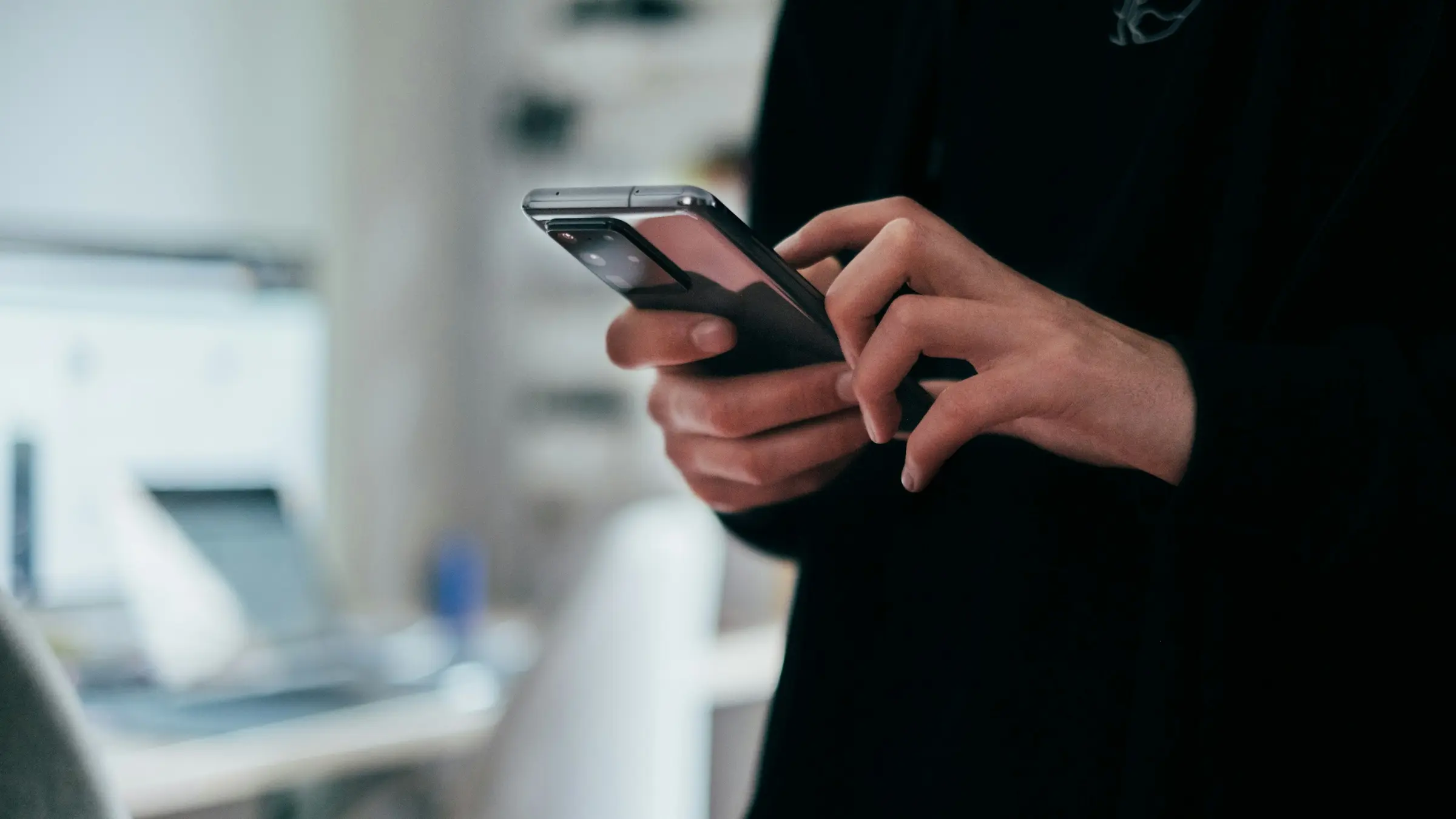 Person typing a message on a smartphone