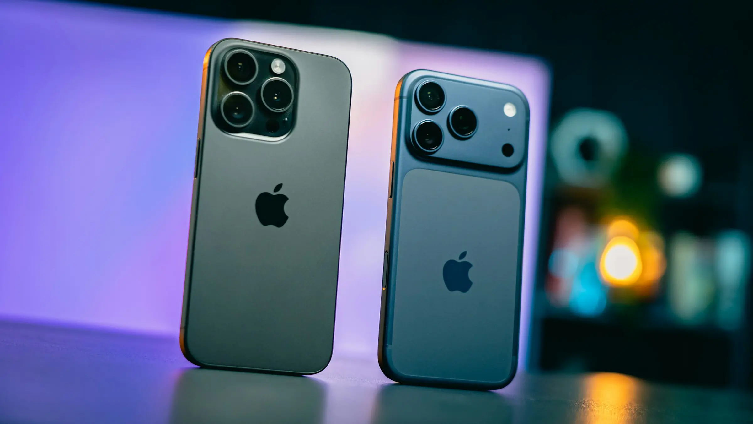 Two smartphones side by side under purple light