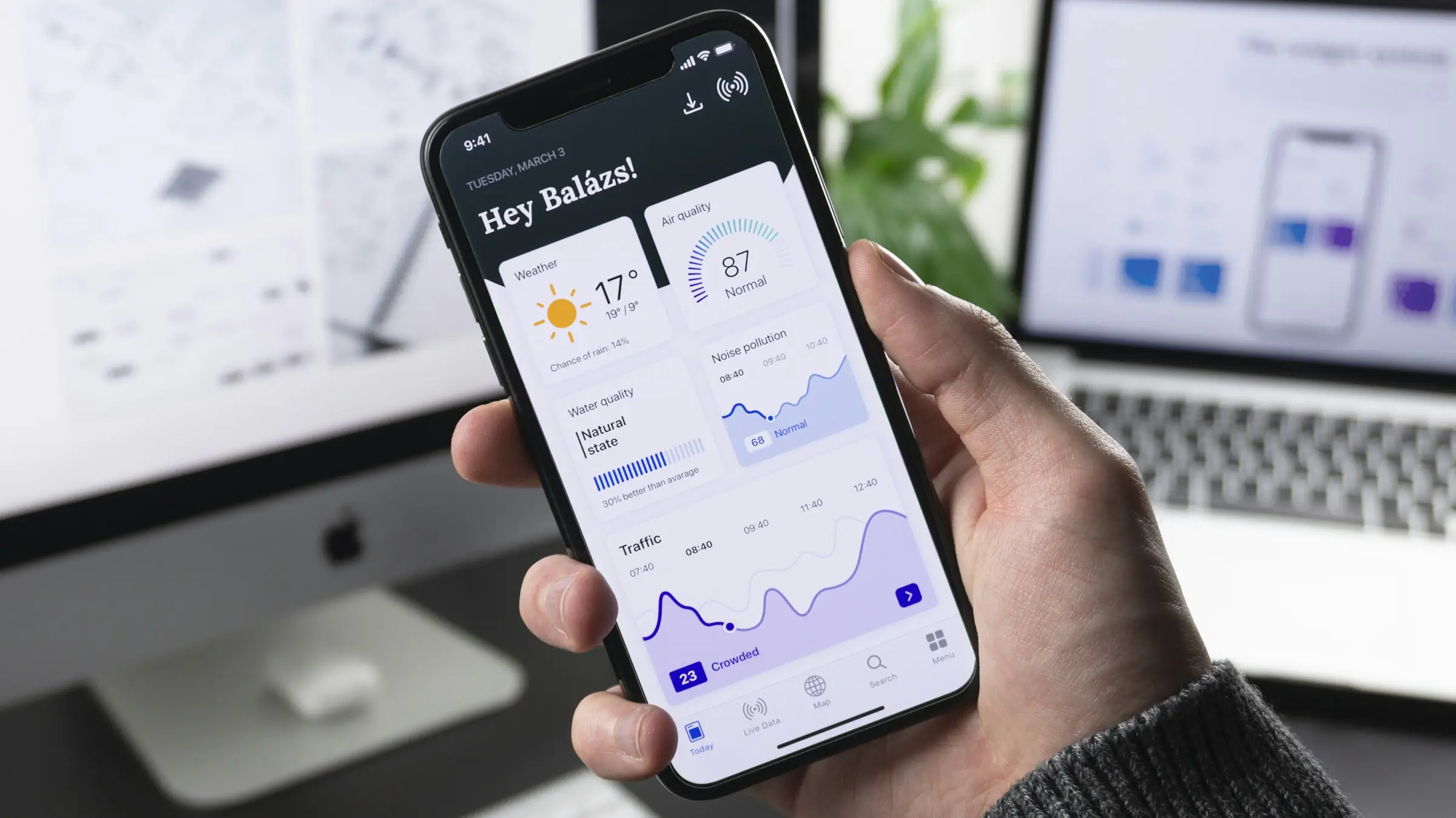Hand holding a phone with a custom app dashboard