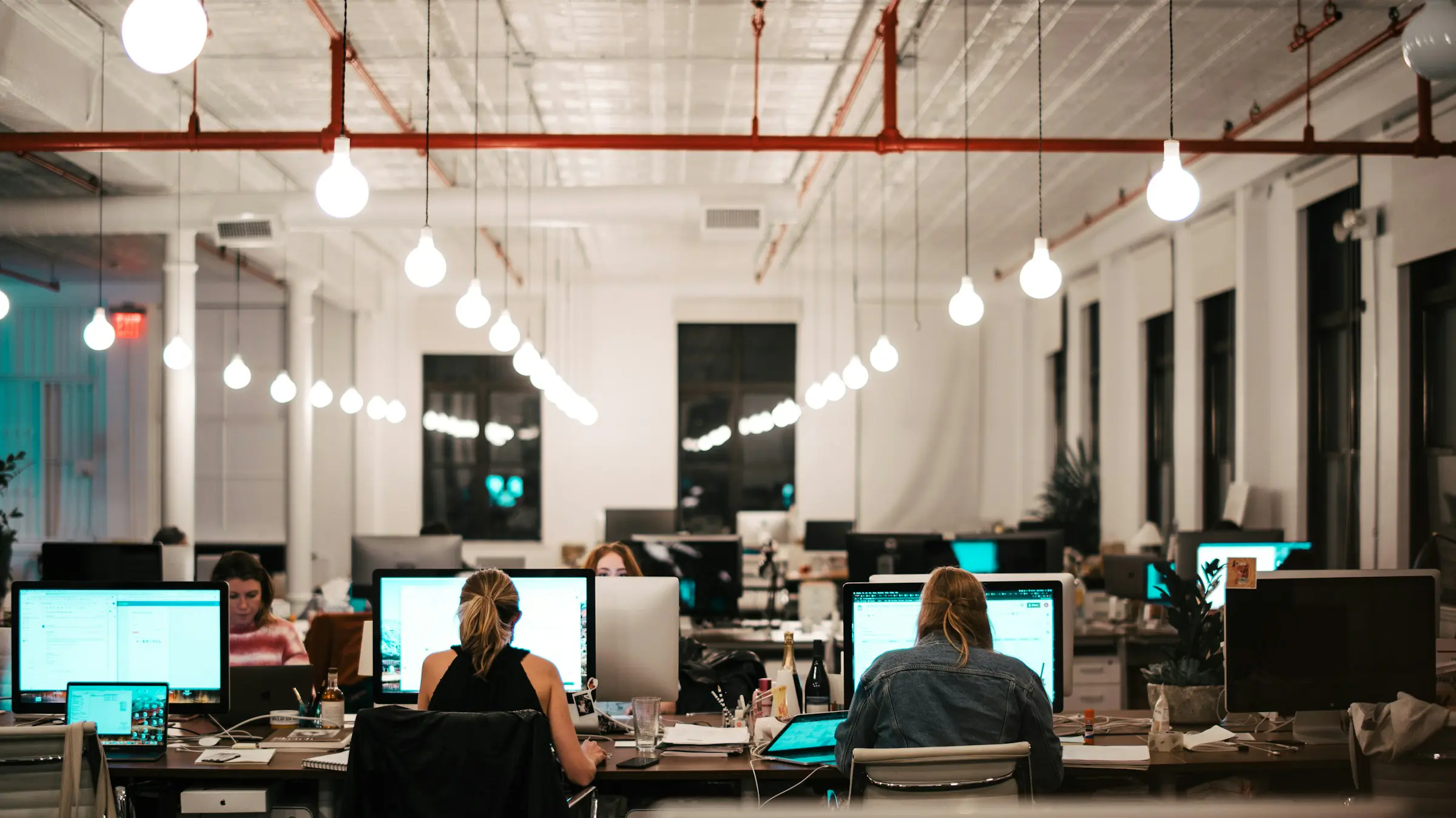 Software developers working at computers in an open office