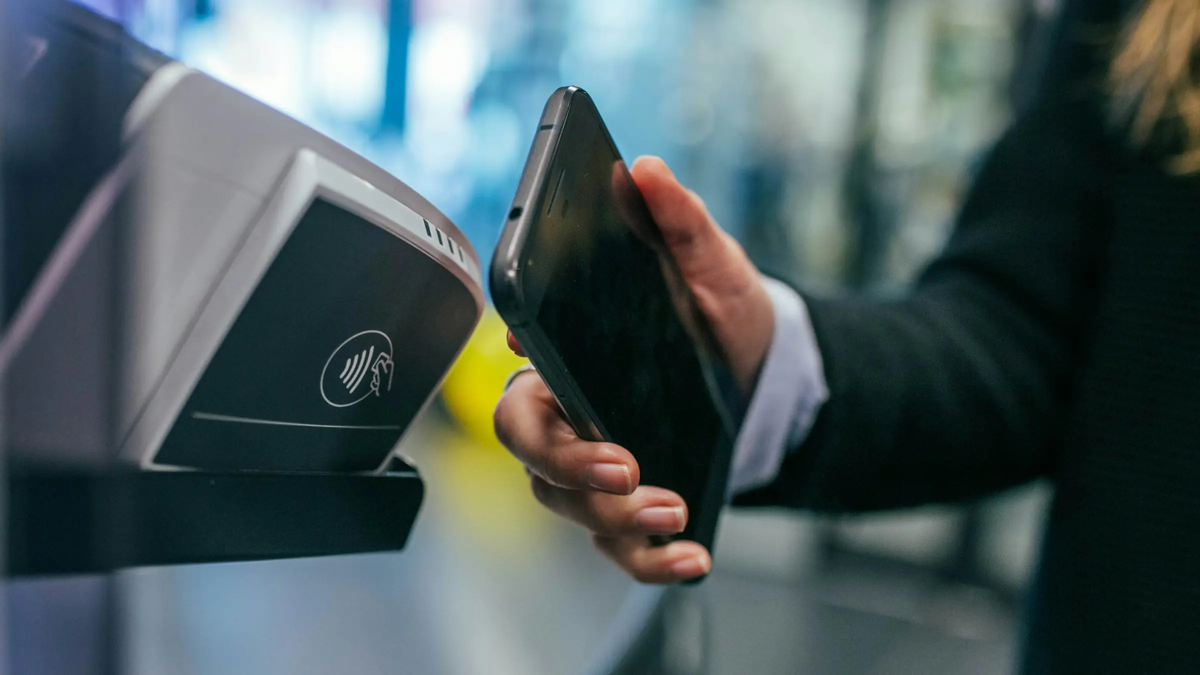 Phone being tapped on a payment terminal to pay