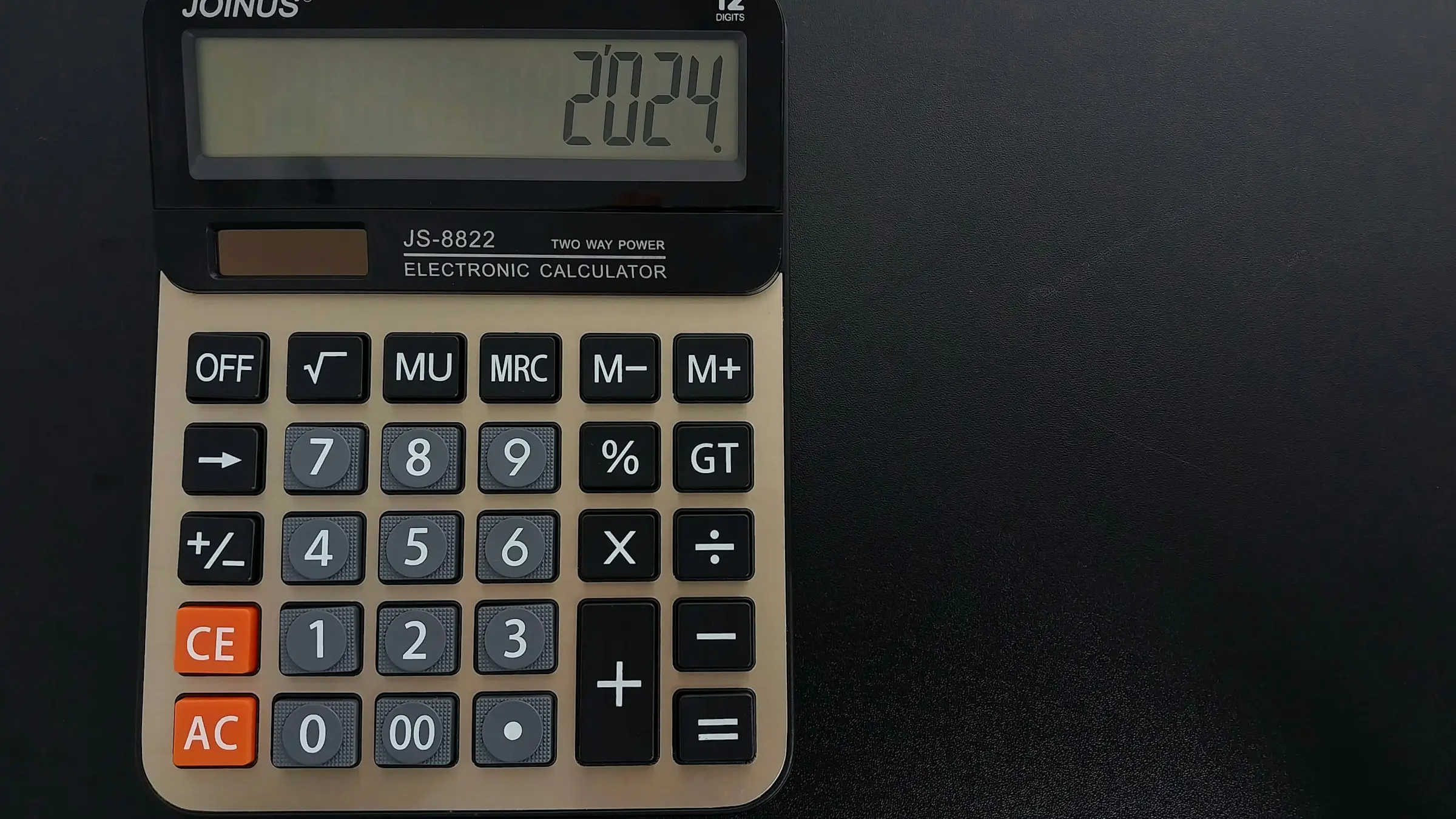 Calculator on a dark desk for estimating app development cost