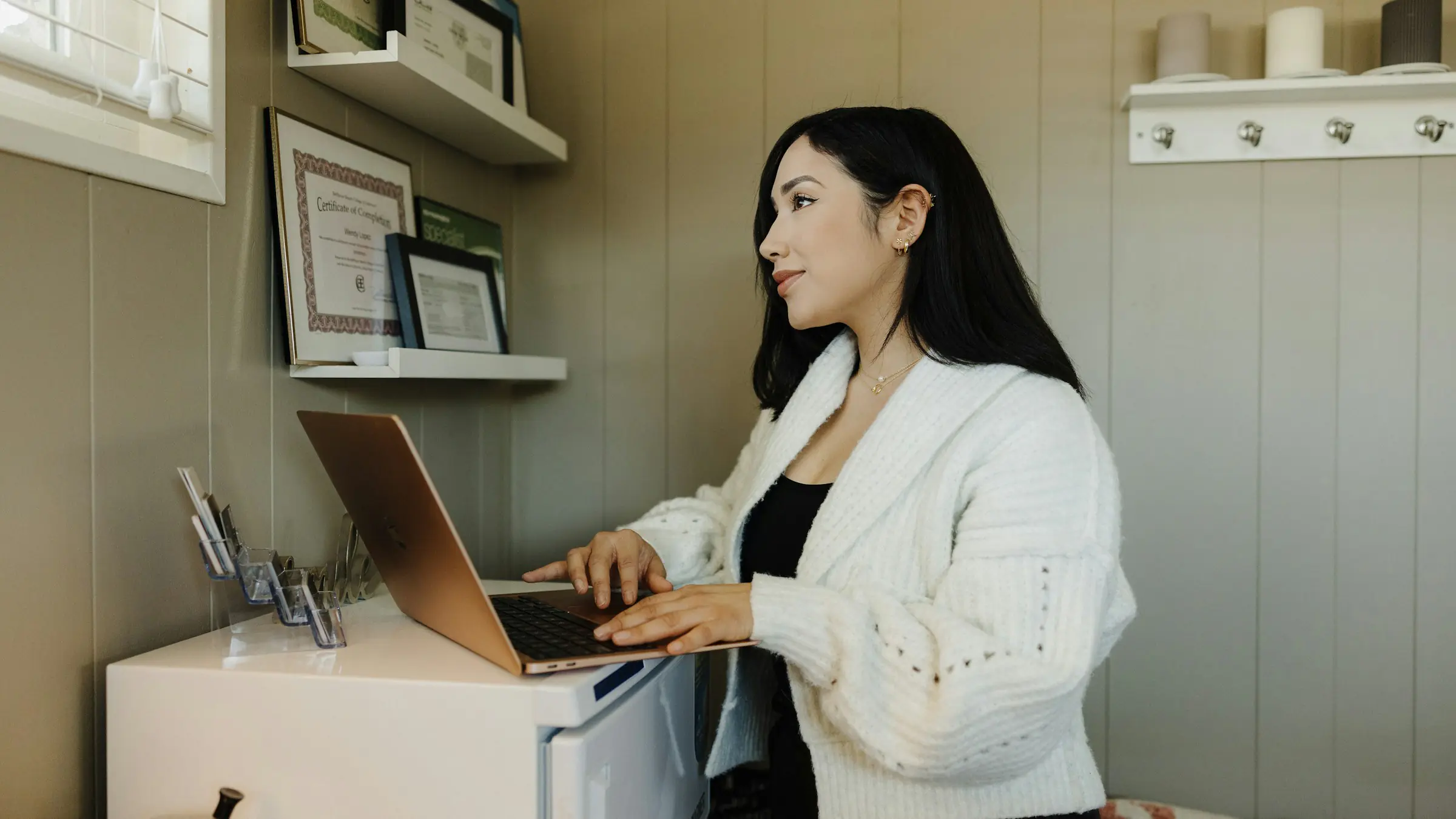Small business owner working on a laptop at her desk