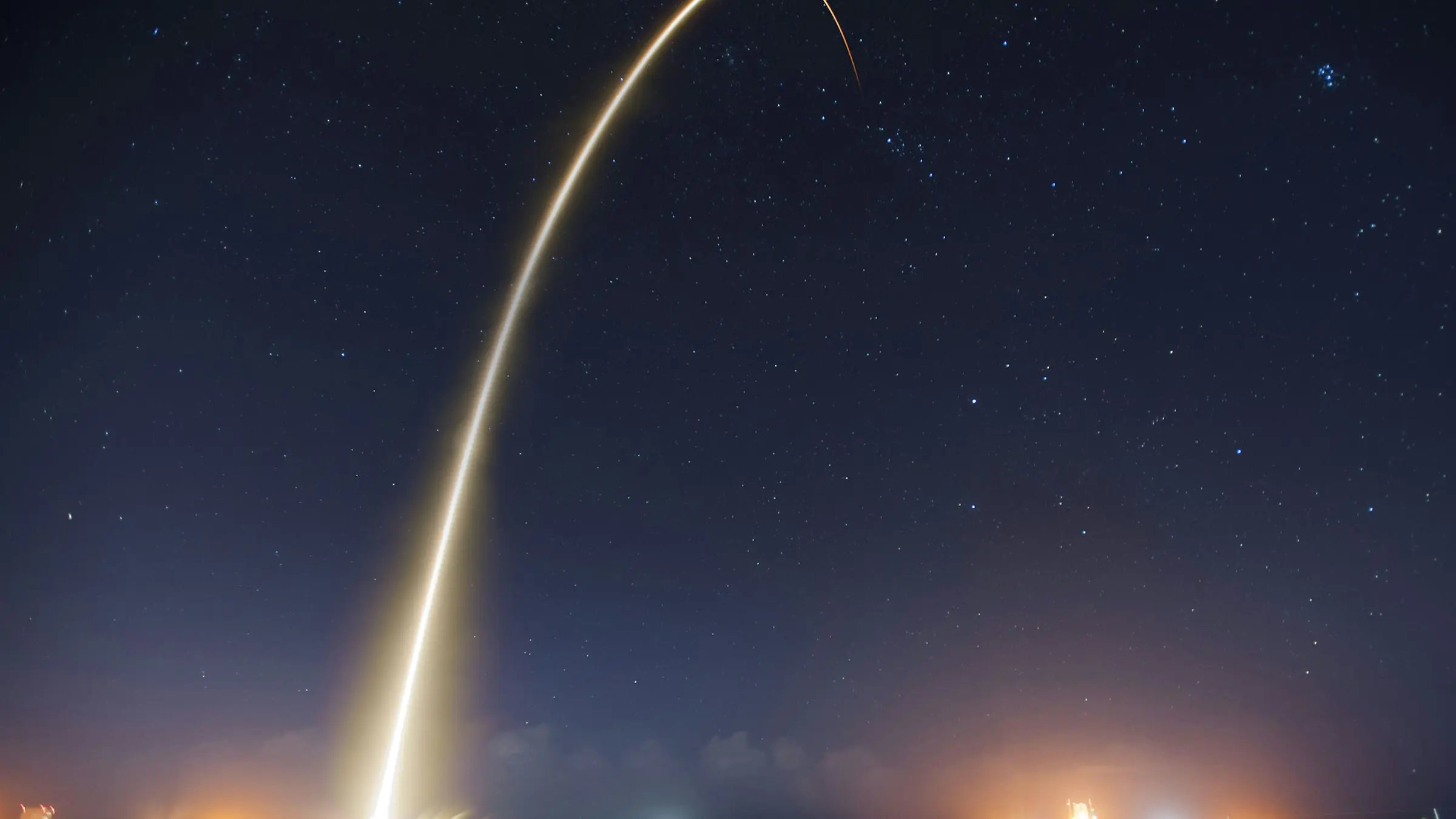 Rocket launch streaking into the night sky