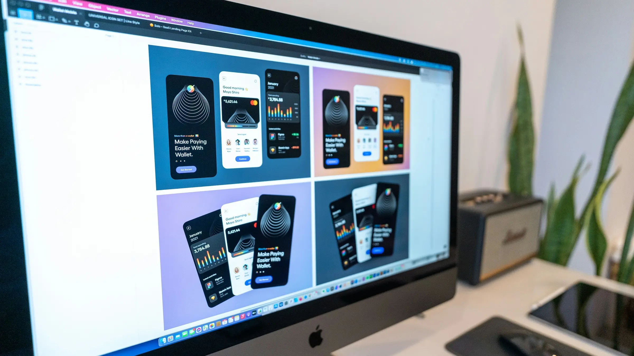 Mobile app screen designs on a desktop monitor