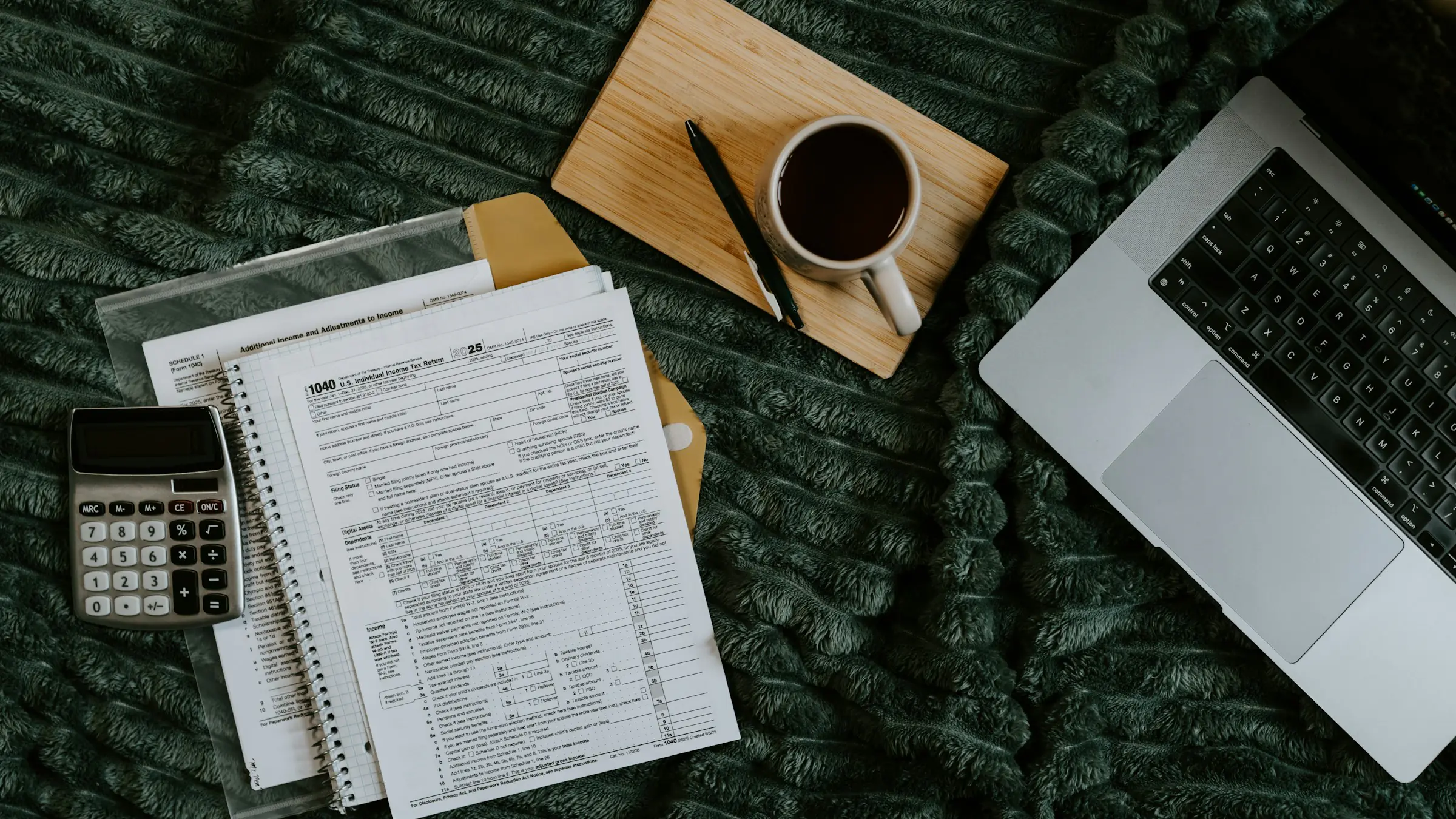 Calculator, invoices and a laptop for budgeting an MVP