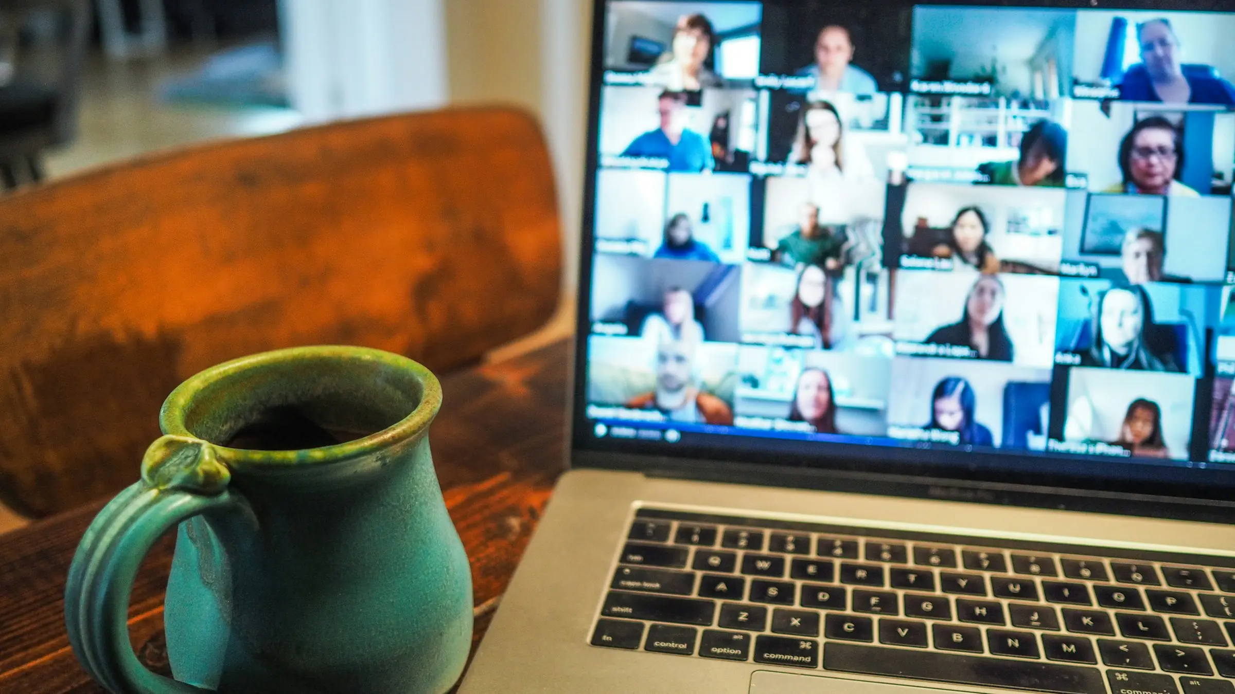 Laptop showing a video call with a distributed team