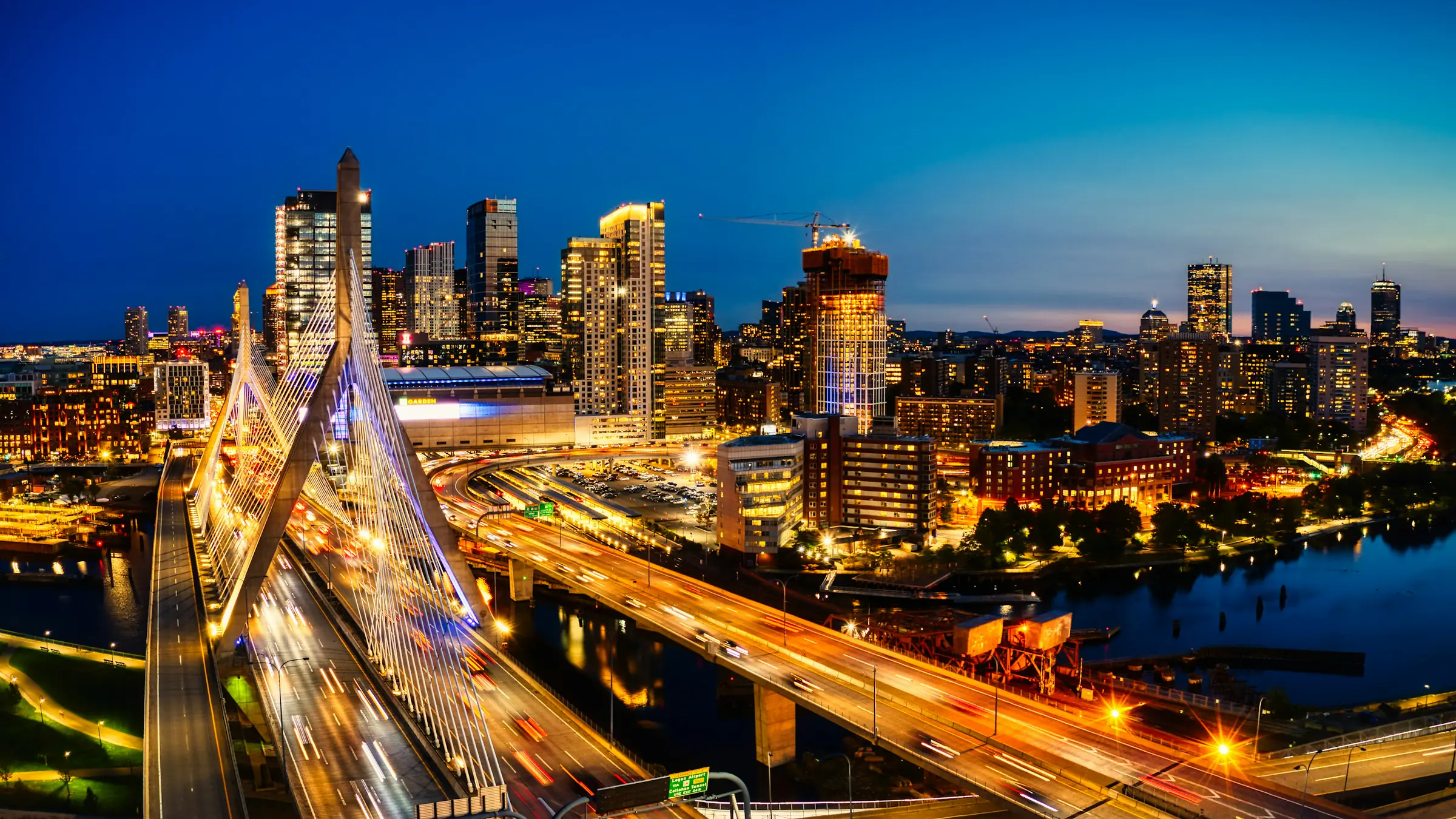 Boston skyline and Zakim Bridge lit up at night