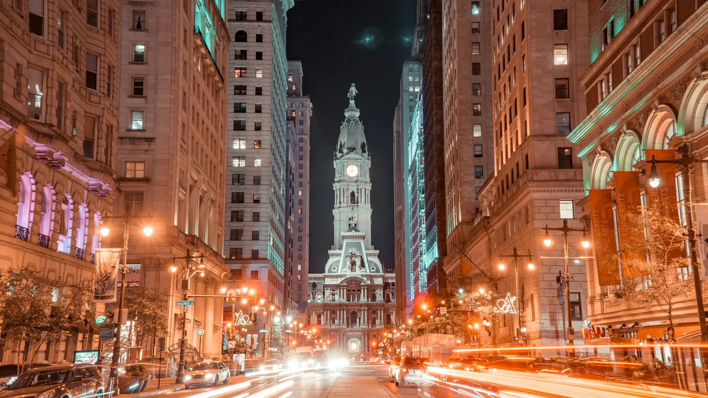 Philadelphia City Hall at night with traffic light trails